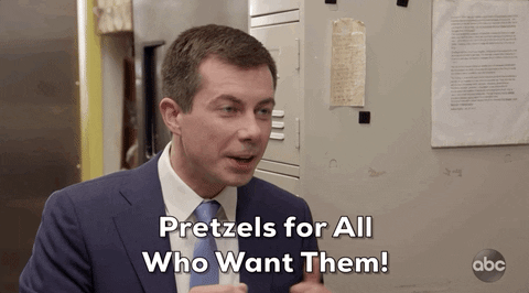 A gif of Pete Buttigieg gesturing with his hands and saying "Pretzels for all who want them!"