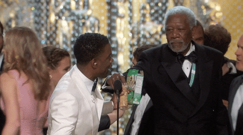 Morgan Freeman takes some Girl Scout cookies at the 2016 Oscars.