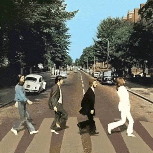 The Beatles walk across Abbey Road.