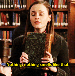 A gif of a girl holding a book
