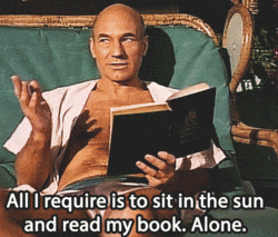 A gif of Captain Jean Luc Picard from Star Trek sitting on a lounge chair with a book in hand. Caption says, "All I require is to sit in the sun and read my book. Alone."