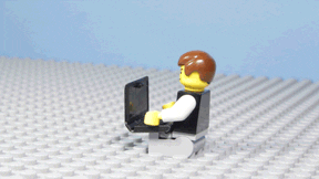 Gif of lego toy typing computer and throwing it away.