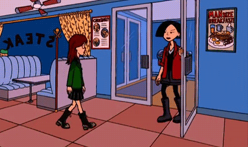 Gif of Daria, a white girl with brown hair, a green jacket, a skirt, and black boots, walking to her best friend, Jane, a white girl with short black hair, blue eyes, red lips, a red jacket, black clothing and boots, and hugging her, from the show Daria