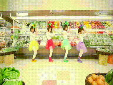 4 women dancing in vegetable costumes in health food store 