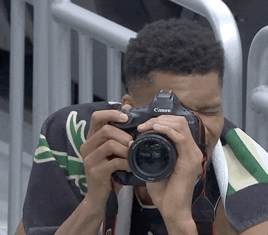 Giannis, the basketball player is taking some photos.  (side hustles)