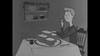 A man sits at a table and eats food continuously. A man sits at a table and eats food continuously.