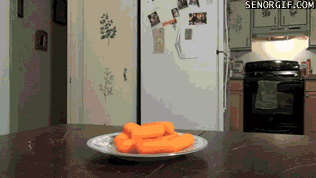 GIF of dog sniffing carrots
