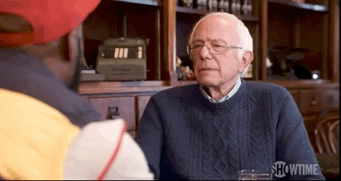 Bernie Sanders shaking his head with a slight grimace, eventually saying "No."
