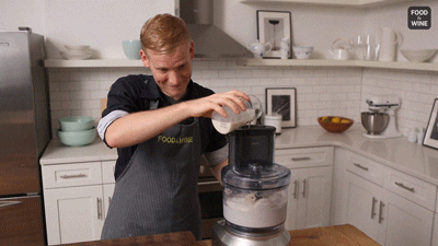 man uses a blender to mix the ingredients of the ice cream
