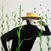 Masked figure in a flat-brimmed hat crouching among paper bamboo stalks