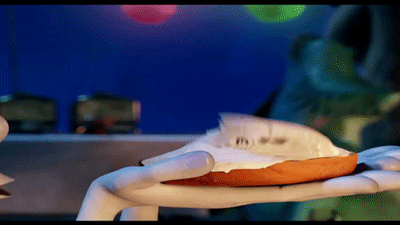 a gif of the scream cheese from hotel transylvania. it is a cookie covered in cream cheese that becomes a little screaming mouth