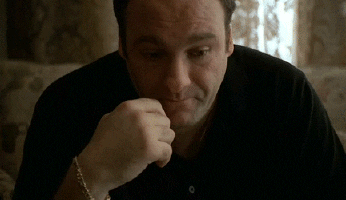Tony Soprano folding his head in his hands, frustrated.