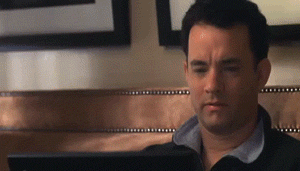 Gif of a scene from the movie "You've got mail" showing Tom Hanks happy and ready to write on his laptop