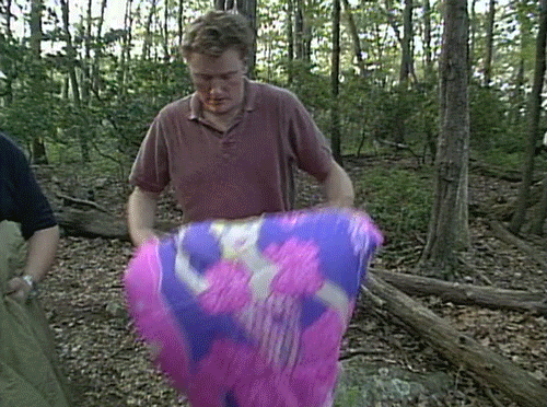 A person laying their barbie blanket on the floor