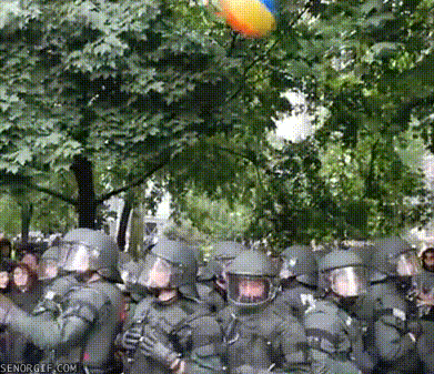 Ball Falls on Police's Helmets During Riot