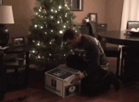 animated gif of opening a christmas present