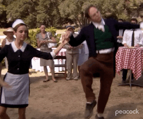 Dwight Schrute from The Office dancing wildly at an outdoor party