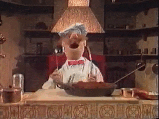 Animated GIF of the Swedish Muppet Chef from The Muppets, joyfully cooking in the kitchen with a chef's hat and apron.