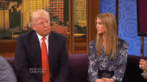 Donald Trump points at his daughter while they sit on a couch during an interview.