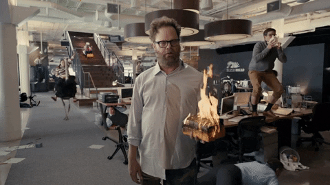 Actor Rainn Wilson in front of office chaos