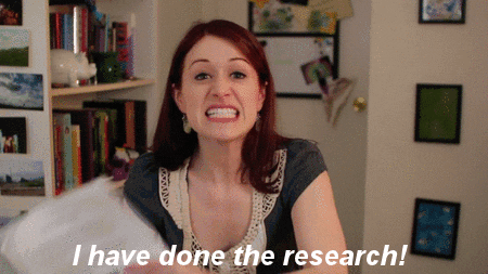 GIF: Woman aggressively holding up her research with the caption 