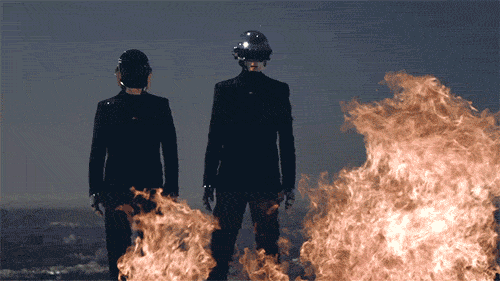 Daft Punk members with fire burning in front of them