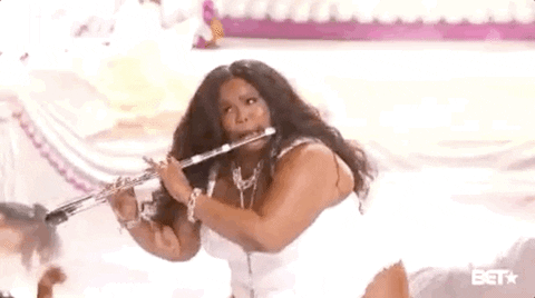 Lizzo playing the flute