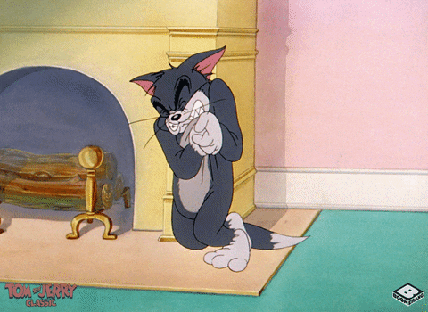 GIF of Tom from Tom and Jerry clutching his heart and falling.