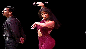 Selena twirling on stage during a dance routine.