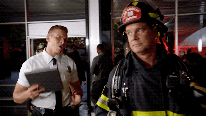 Gif of a firefighter walking and looking annoyed.
