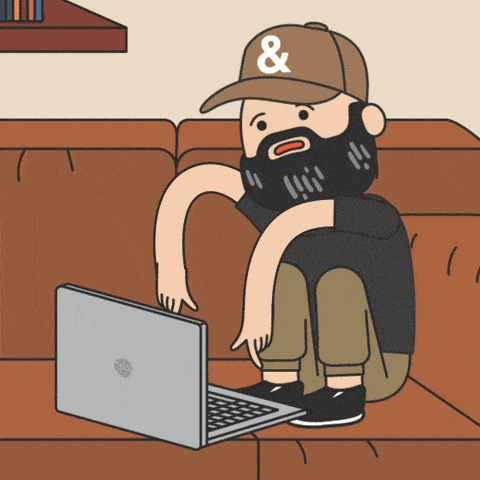 a man typing on a computer on fire on his couch