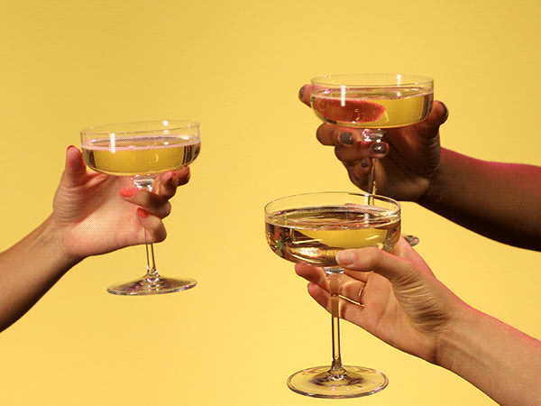 three hands clink champagne glasses