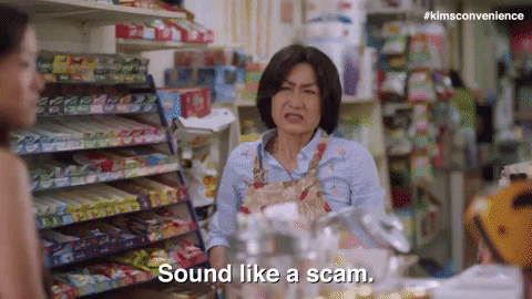 An Asian lady who is working in a supermarket. She is saying "sound like a  scam" to a customer.