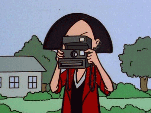 personagem do desenho Daria dos anos 90 tirando uma foto com uma câmera Polaroid