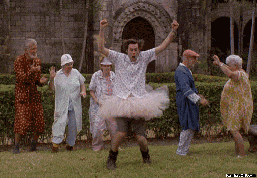 Jim Carrey wearing a tutu and doing crazy dancing while on his background are five elders dancing along