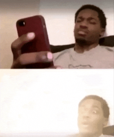 Man frowning at his phone screen, confused by what he is reading