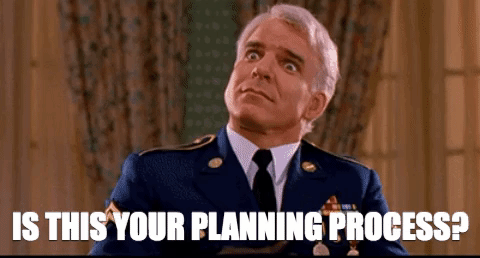 This is a GIF of Steve Martin from the movie Dirty Rotten Scoundrels. He is placing his fingers on his temples as if he's thinking, then shrugging it off, and the words "Is this your planning process?" are the bottom of the GIF.