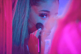 Attribution: [Image description: Ariana Grande pursing her lips and applying blush to her cheeks.] Via Giphy