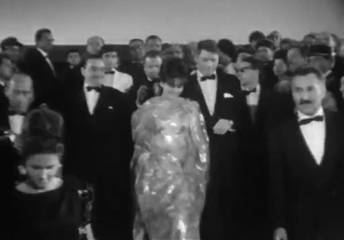 actors in black and white walking down steps gif 