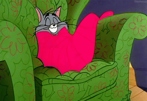 Tom (from Tom & Jerry) getting cozy on an armchair.
