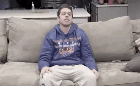 GIF of a person slouching down on a couch