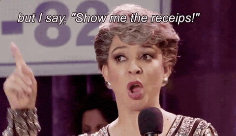 Unbreakable Kimmy Schmidt: a woman at a microphone raises one finger and says "Show me the receipts!"