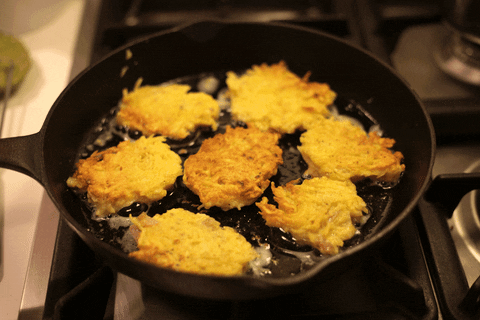 latkes sizzling in a frying pan