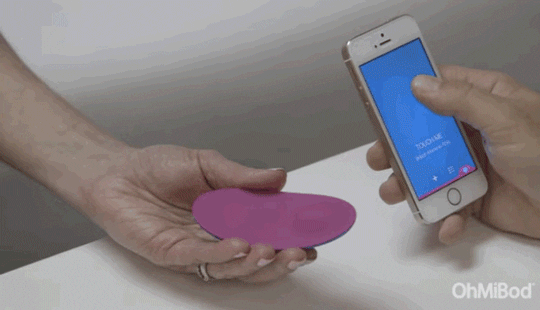 A woman tests out a sex toy that can be controlled via her mobile phone