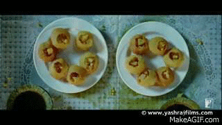 A man and a woman eat an Indian snack 'pani puri.