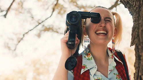 girl holding an oldschool video camera capturing video content marketing
