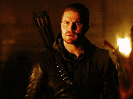 Oliver Queen in full Arrow gear, looking moody