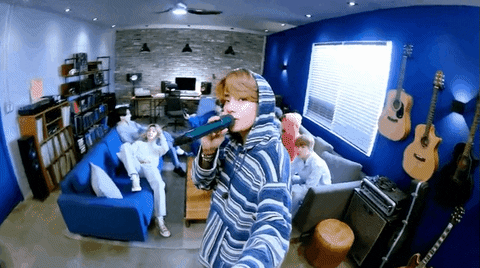 A GIF of BTS performing live in socially-distanced settings via Giphy