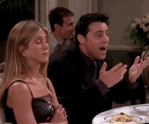 Joey Tribiani from Friends at a dinner with Rachel, very excited. The caption reads, 