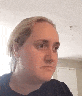 Woman looking sideways with an expression of doubt, weighing options